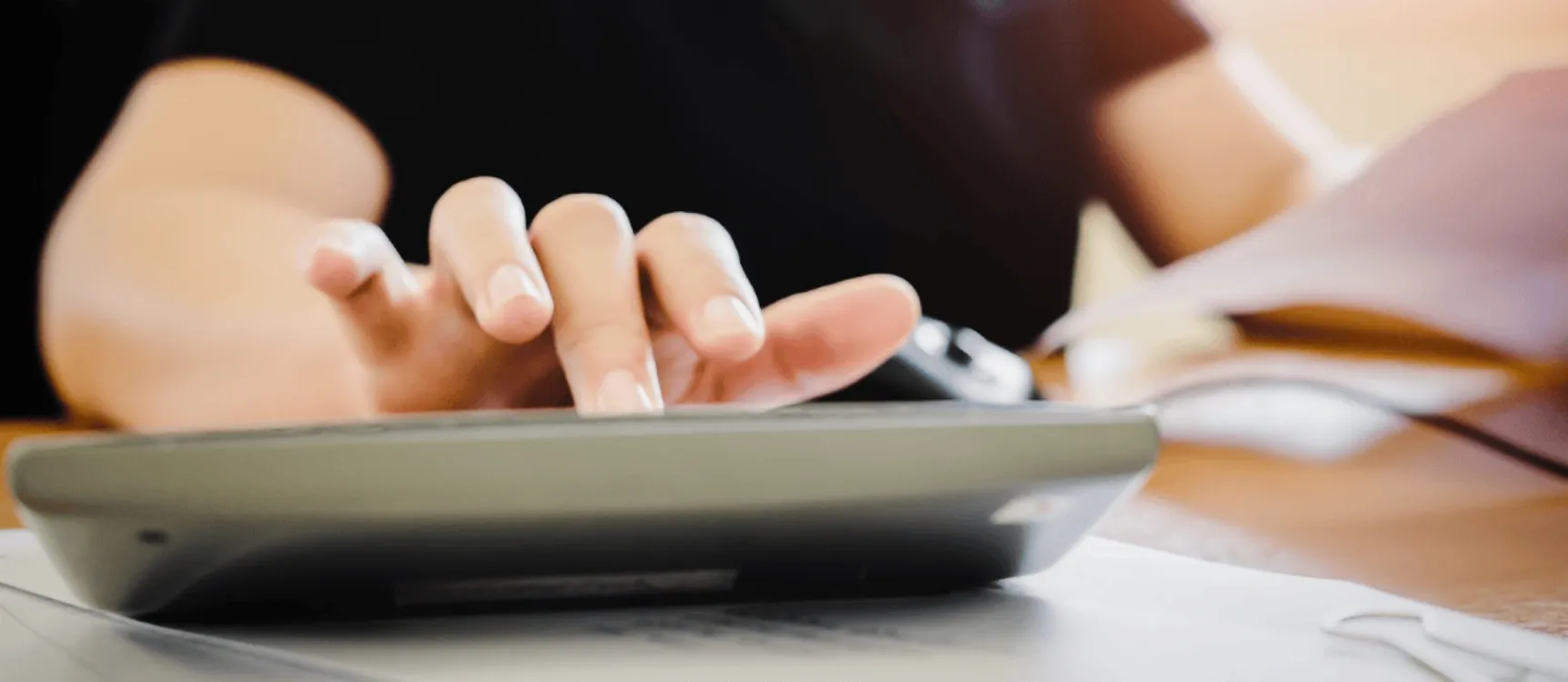 Gerontopsychatrische Fachkraft tippt Gehalt in Taschenrechner